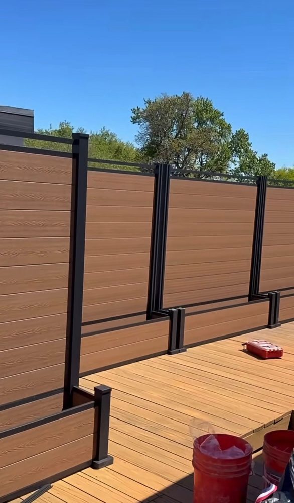 Fencly Fence with Planter Box: teak WPC privacy screen panels with integrated composite planter boxes along a timber-look deck.