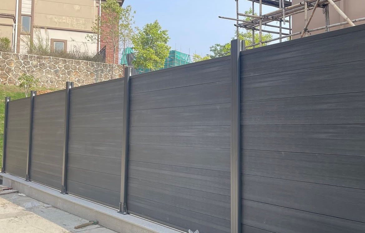 Fencly Privacy Fence: full-coverage charcoal WPC privacy panels along a long boundary.
