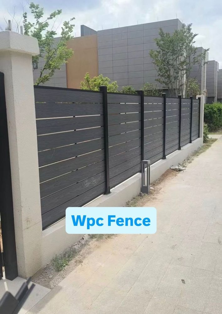 Fencly Full Trellis: charcoal open-board WPC composite fence with aluminium posts along a residential boundary.
